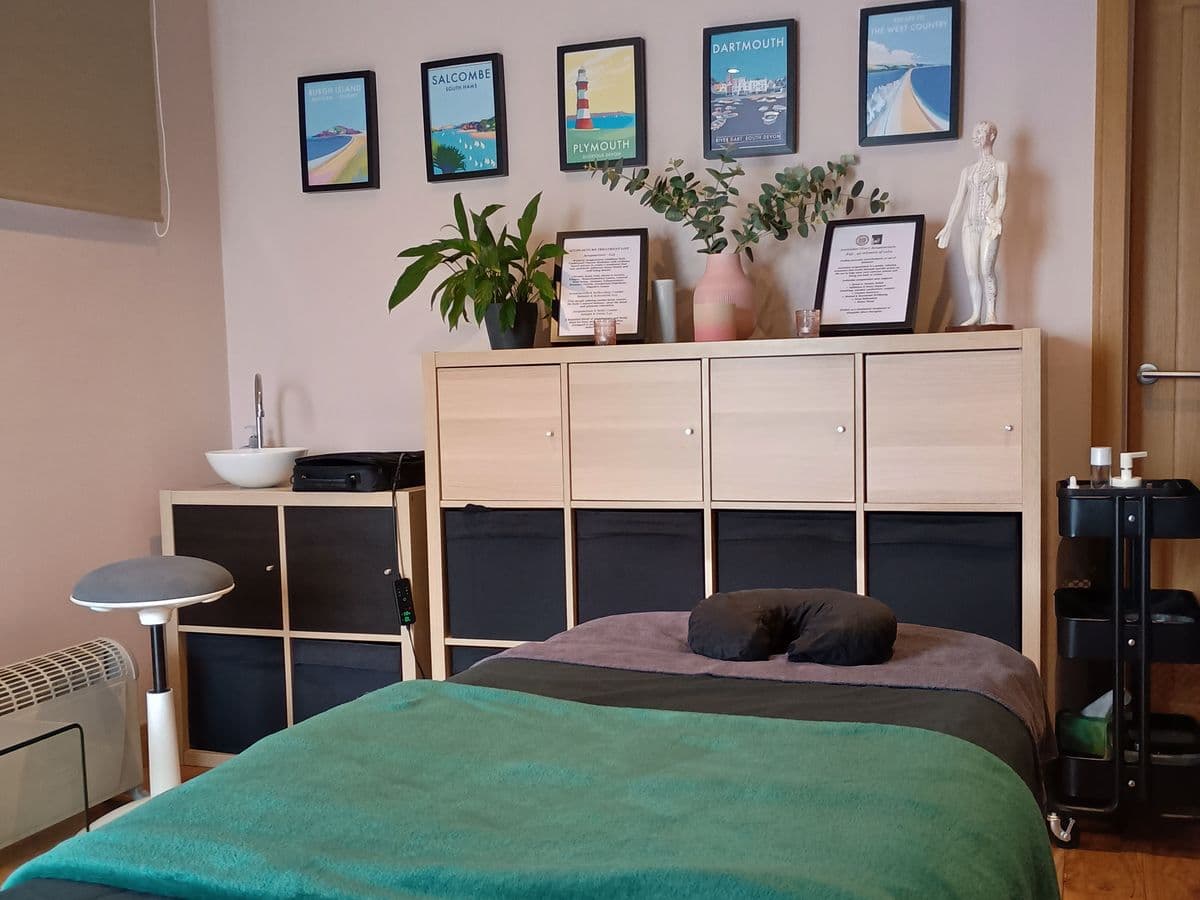 Rachel's treatment room, with a massage couch and framed Devon prints